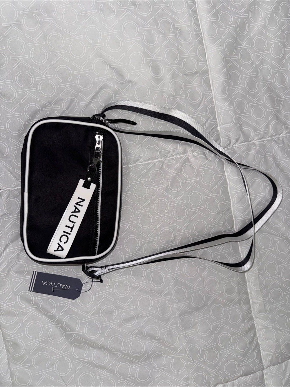 Nautica Black Crossbody Bag with White Trim and Striped Strap